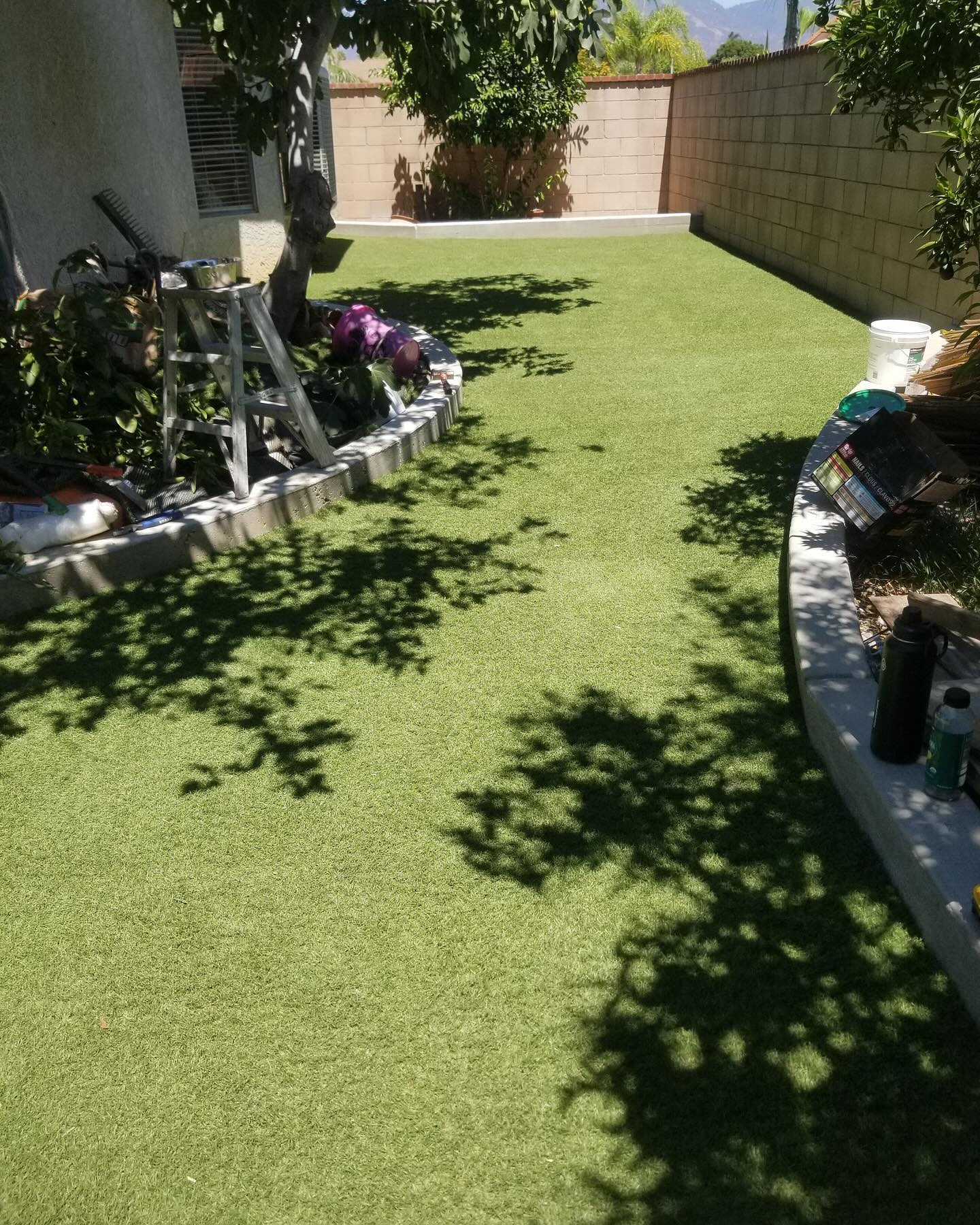 Finished turf installation with curved concrete curb by Mountain Ridge Renovations